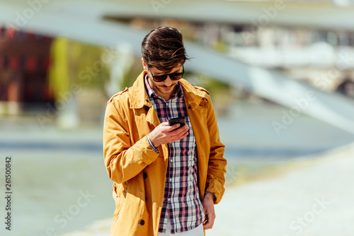 Stylish businessman watching in his smartphone