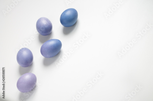 painted eggs on a light purple background Easter