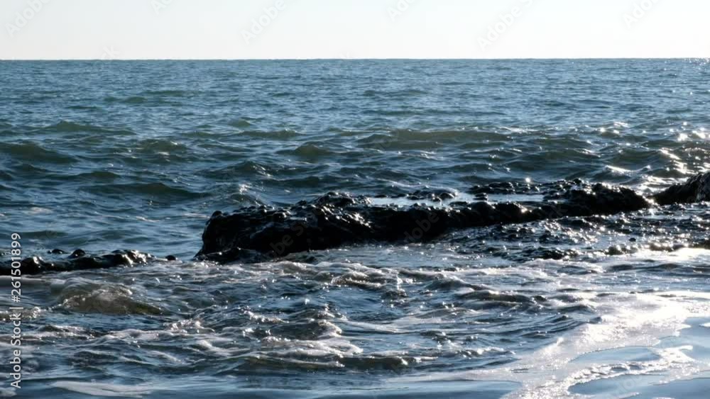 Slow motion shooting motion of sea waves. Close-up shot of the sea wave. The spray is flying in different directions. The surf of the sea. Slow motion shooting motion of sea waves. Close-up shot of the sea wave. The spray is flying in different directions. The surf of the sea.