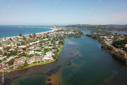 Aerial view of Narrabeen Lake, Narrabeen Beach, Collaroy Beach and Long Reef Head. Sydney CBD in the background.