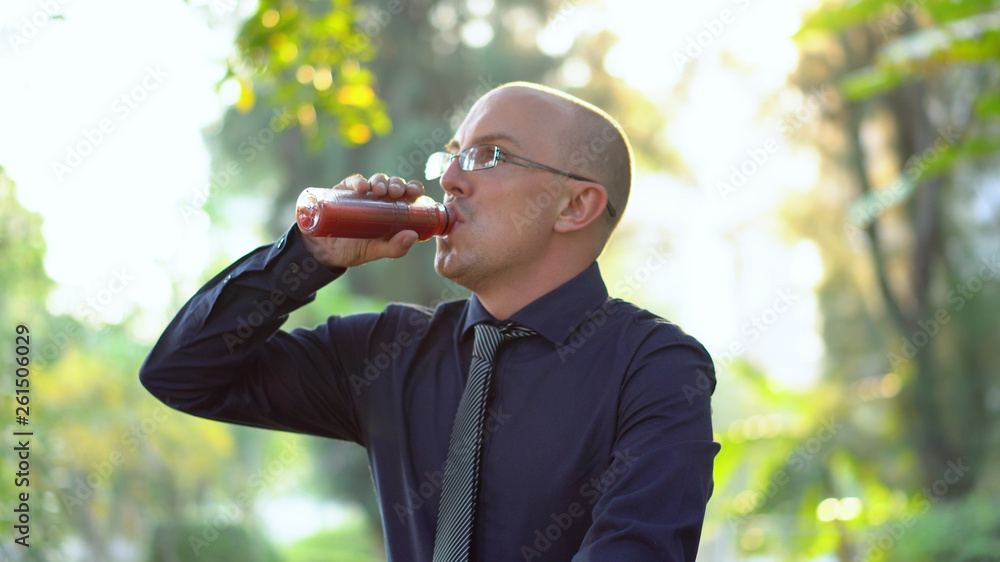 Late 20s Office Worker Drinking Healthy Smoothie in Park