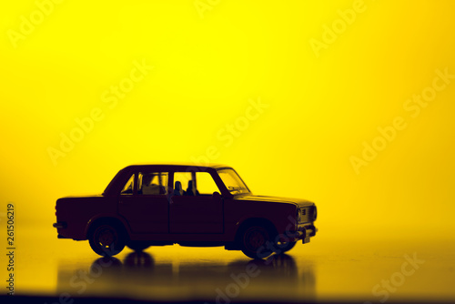 Silhouette toy car on a vibrant red background. photo