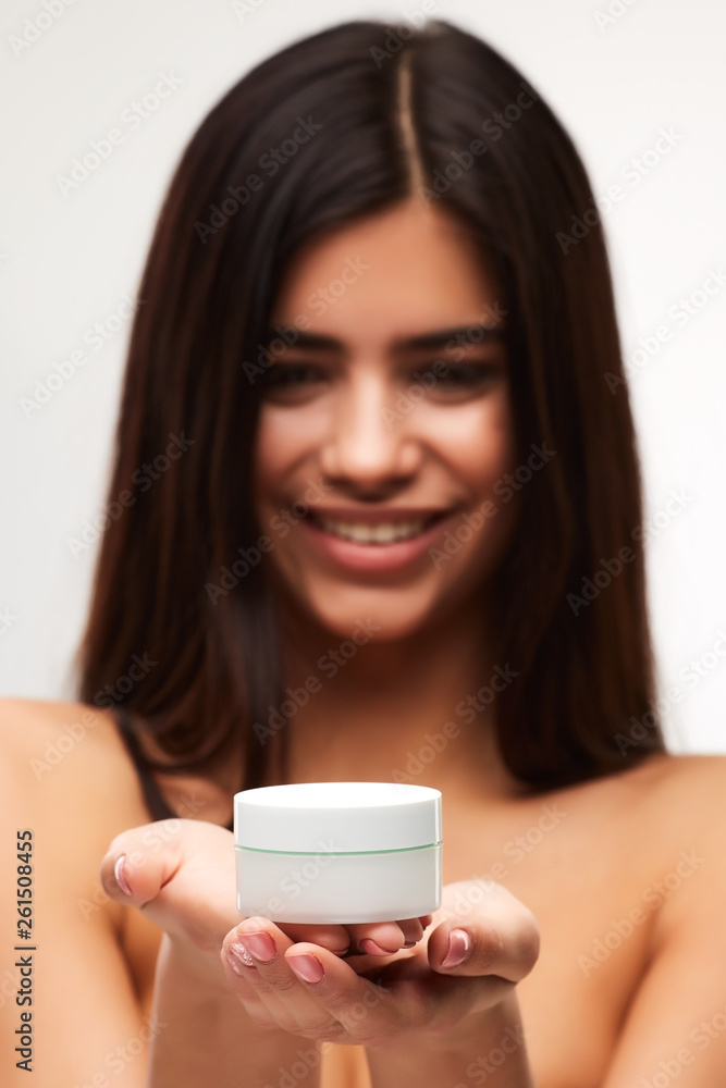 Beauty Face Care. Portrait Of Beautiful Happy Girl With Natural Makeup Holding cream jar In Hand. Beauty Face Care. Portrait Of Beautiful Happy Girl With Natural Makeup Holding cream jar In Hand.