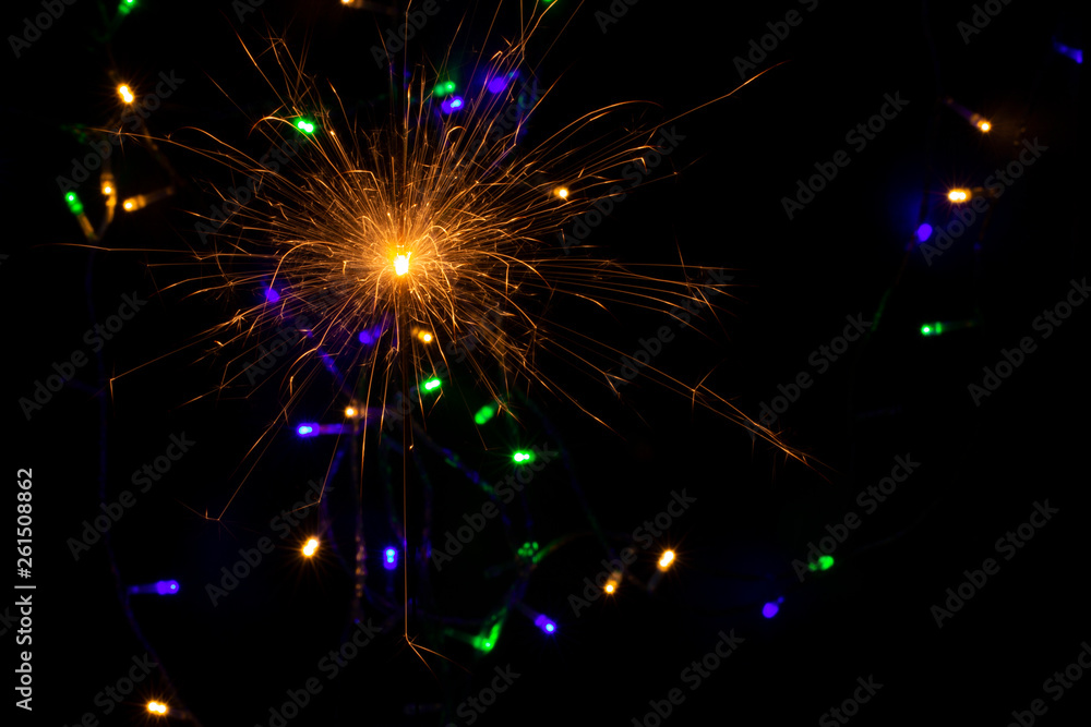 sparkler with blur new year's light close up sparkler with blur new year's light close up