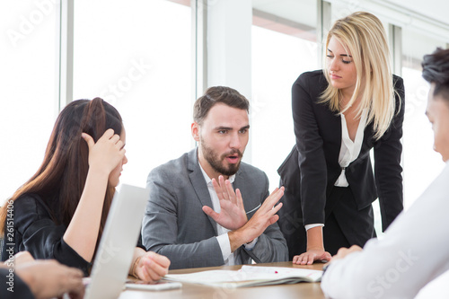business man presenting and disagree sign  in meeting room . Group of young business people brainstorming together in office. teamwork conference. discussing reject new plan photo