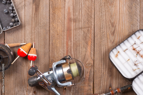 Fishing tackle on wooden background. Accesories for fishing with copyspace .