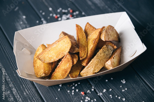 Baked potatoes.Snack in paper eco-friendly boxes. Takeout food in a paper box. Fast food on the street. To go Snacks.