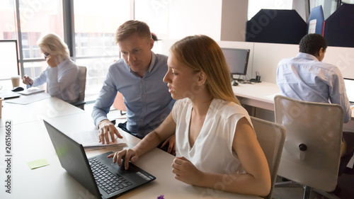 Female manager consult client in office with laptop at meeting