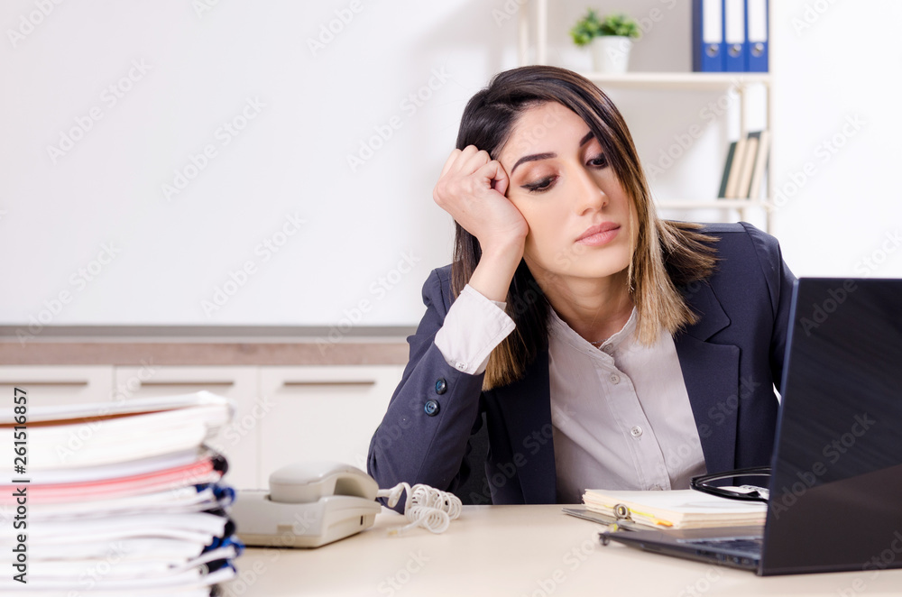 Young female employee working in the office Young female employee working in the office