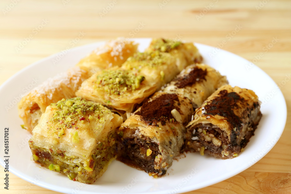 Plate of Baklava Pastries in Different Flavors Served on Wooden Table Plate of Baklava Pastries in Different Flavors Served on Wooden Table