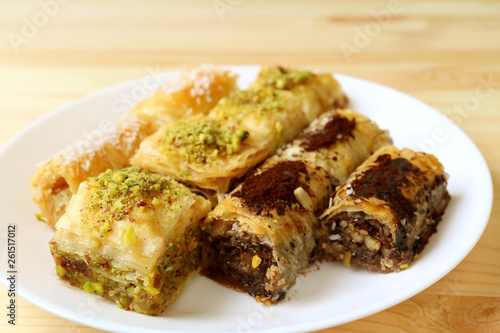Plate of Baklava Pastries in Different Flavors Served on Wooden Table