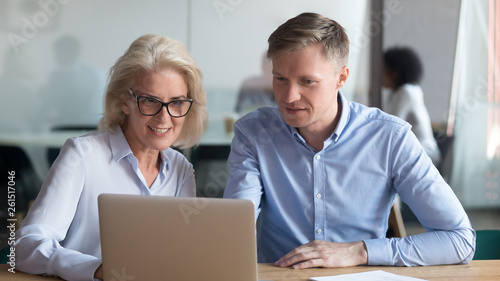 Middle aged manager make business offer to client on laptop