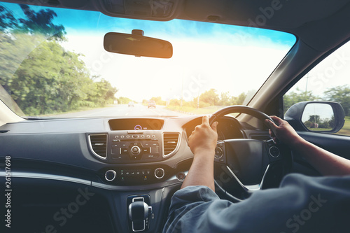 Man driver hands holding the car steering panel photo