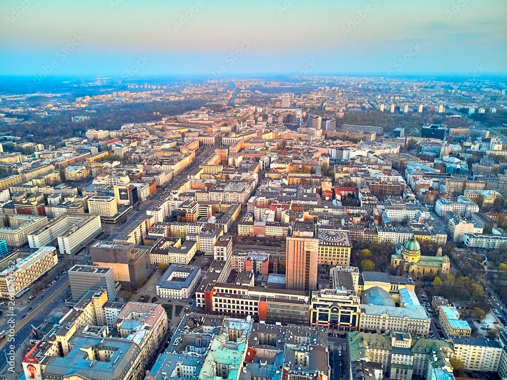WARSAW, POLAND - APRIL 07, 2019: Beautiful panoramic aerial drone view to the center of Warsaw City in the sunset time in spring