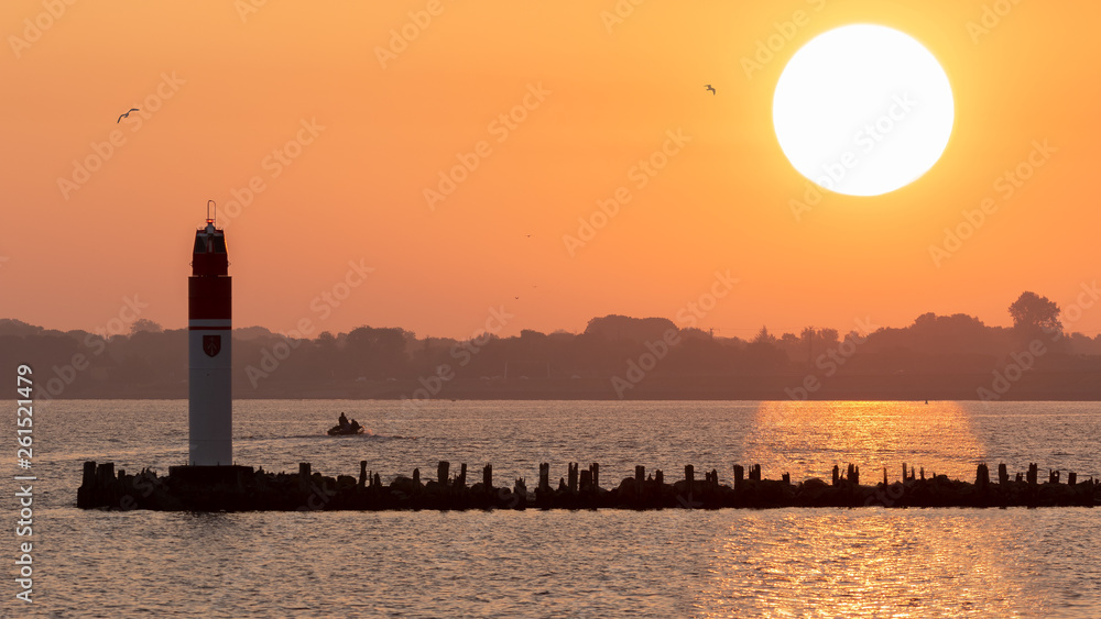 A sunrise over the Baltic island Rügen photographed in the harbor of Stralsund