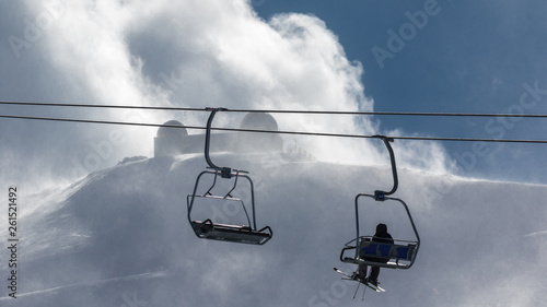 Chairlift for skiers in blizzard high up in the Sierra Nevada