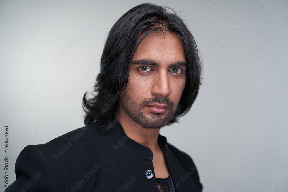 Portrait of Indian man with long black hair in studio Portrait of Indian man with long black hair in studio