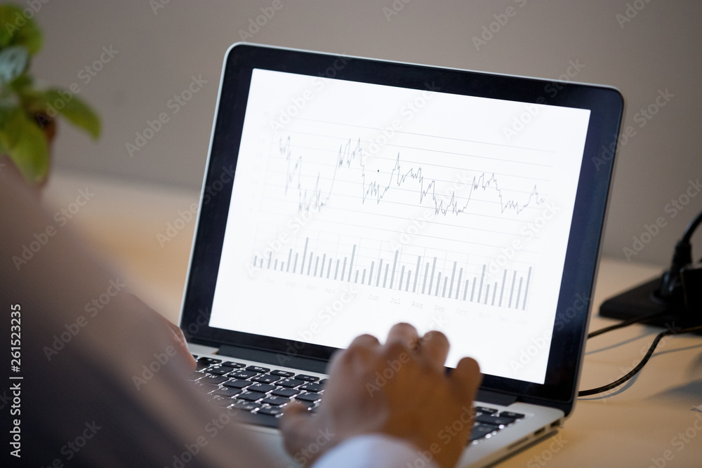 Fototapeta premium Rear view at african business man analyze annual financial report