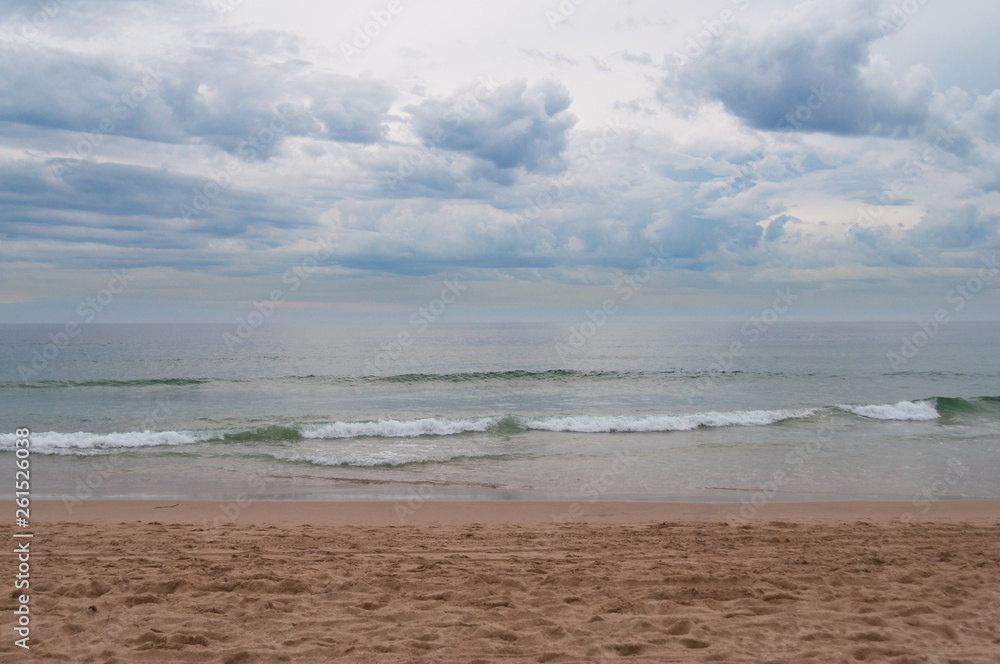 Calm ocean with soft waves and overcast sky