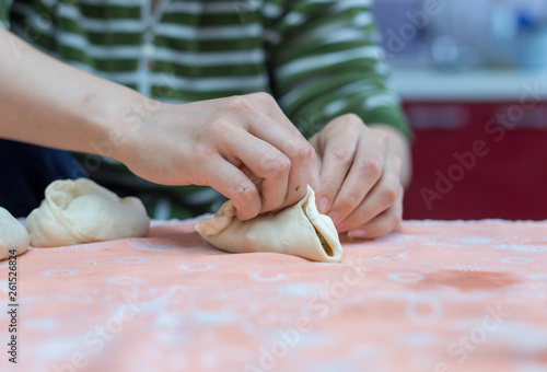 Woman cooks delicious pies (samsa)