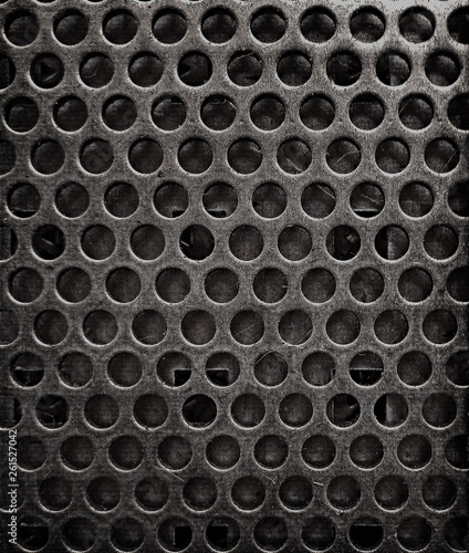 Grunge texture of metal sheet background with holes.