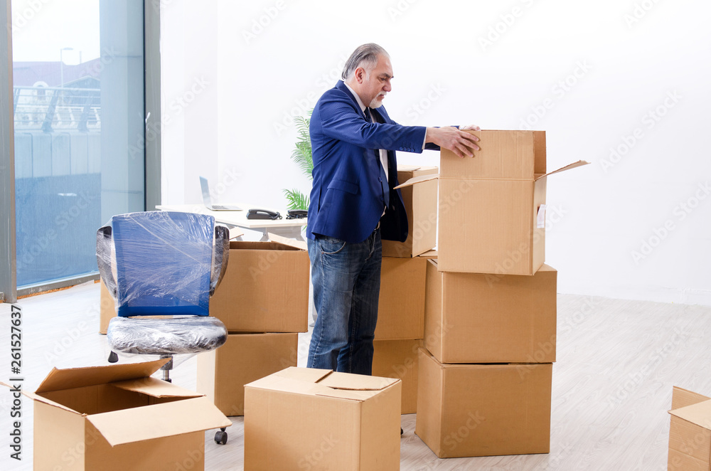 Aged businessman moving to new workplace Aged businessman moving to new workplace