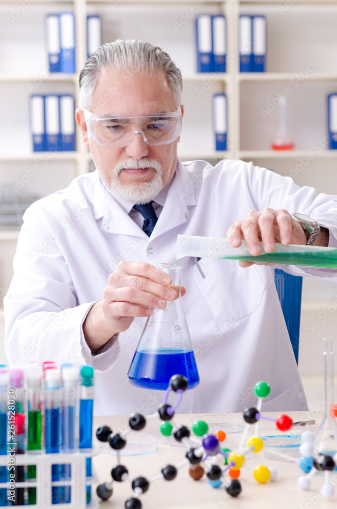 Old male chemist working in the lab Old male chemist working in the lab