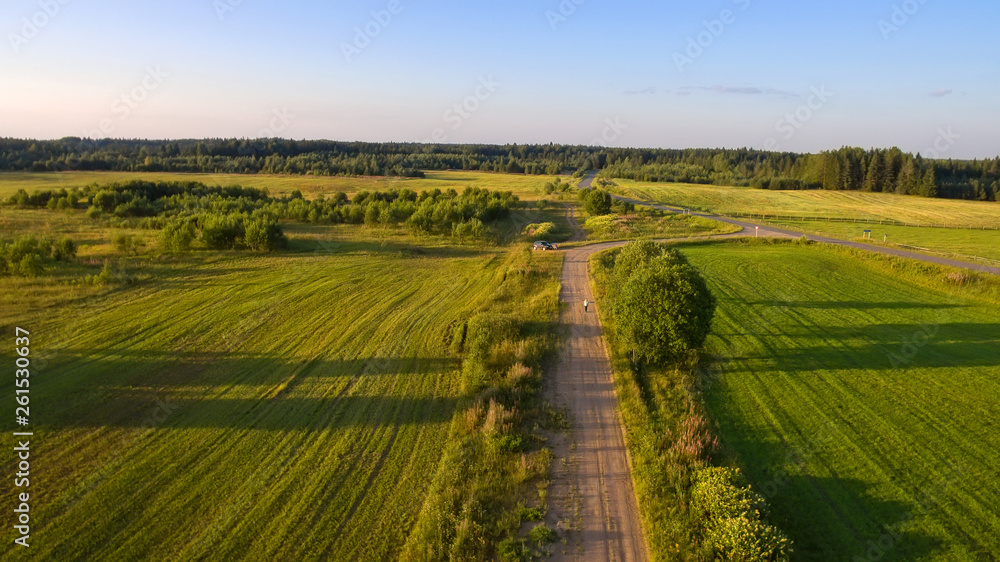 Top view of a country road through an agricultural field