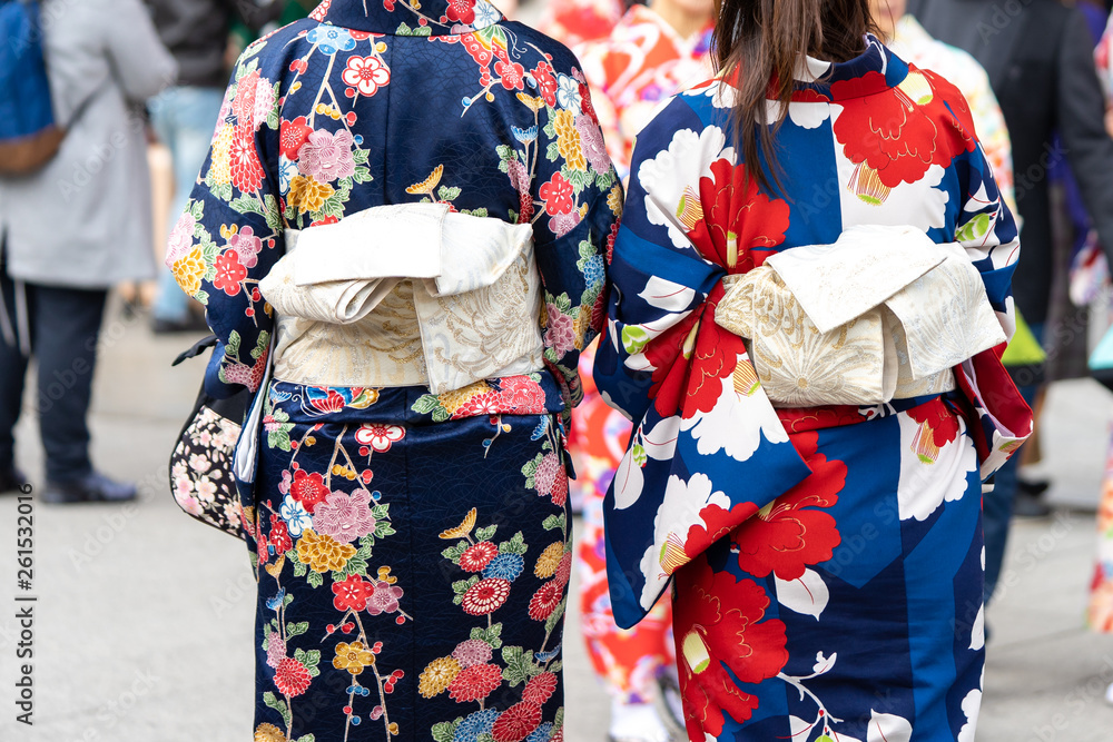 Young girl wearing Japanese kimono standing in front of Sensoji Temple in Tokyo, Japan. Kimono is a Japanese traditional garment. The word 