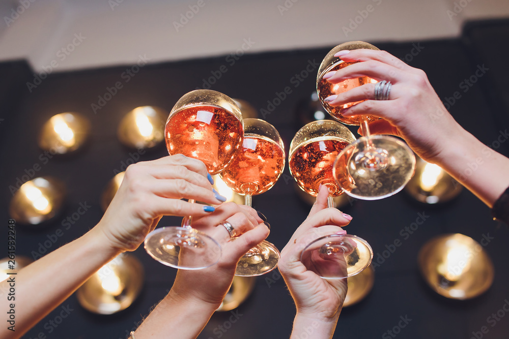 Close up image of woman hands with stylish manicure holding glasses with champagne , black and white style, party time. Cheers. - obrazy, fototapety, plakaty 