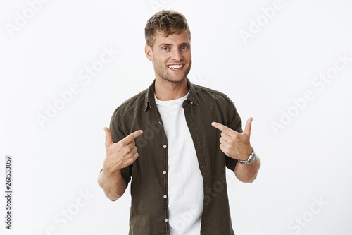 You need me. Portrait of self-satisfied and confdent good-looking charismatic man applying for job pointing at himself proudly and assured, smiling wanting be picked or chosen over grey background