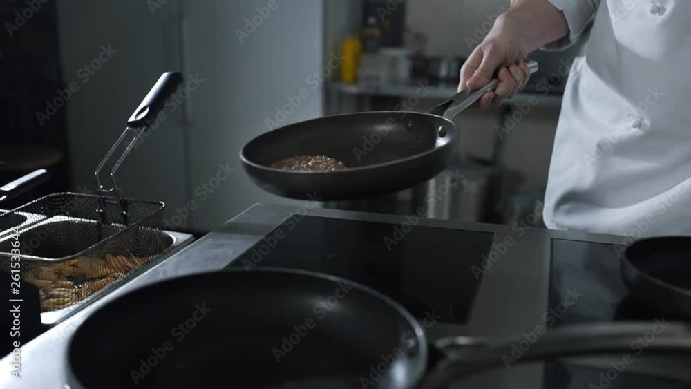 Chef tosses roasting beef on the hot pan at the restaurant kitchen in slow motion, beef meat roasting with smoke and steam, cooking meat for burger, 4k UHD 60p Prores HQ 422 Chef tosses roasting beef on the hot pan at the restaurant kitchen in slow motion, beef meat roasting with smoke and steam, cooking meat for burger, 4k UHD 60p Prores HQ 422