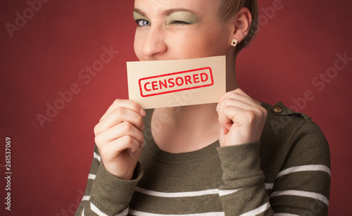 Young person holding adult content card in hand 