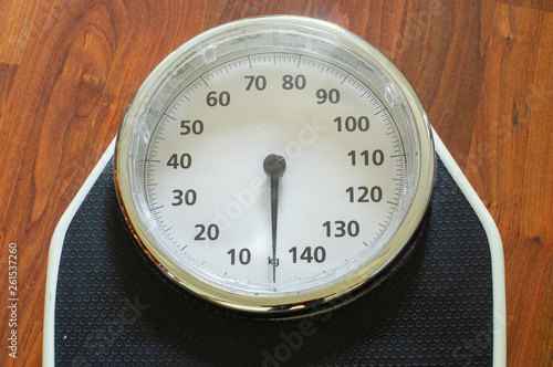 Close-up of a Weight scale on a wooden floor