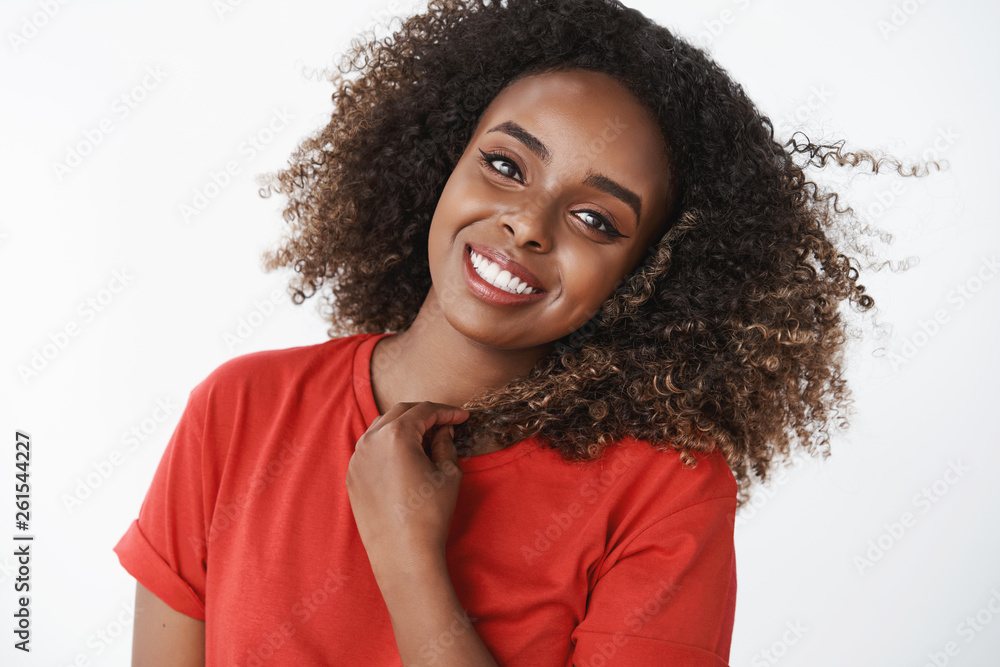Close-up shot of energized and active positive good-looking african-american woman waking up happily starting day with jogging wearing red t-shirt tilting head optimistic and lovely over white wall Close-up shot of energized and active positive good-looking african-american woman waking up happily starting day with jogging wearing red t-shirt tilting head optimistic and lovely over white wall