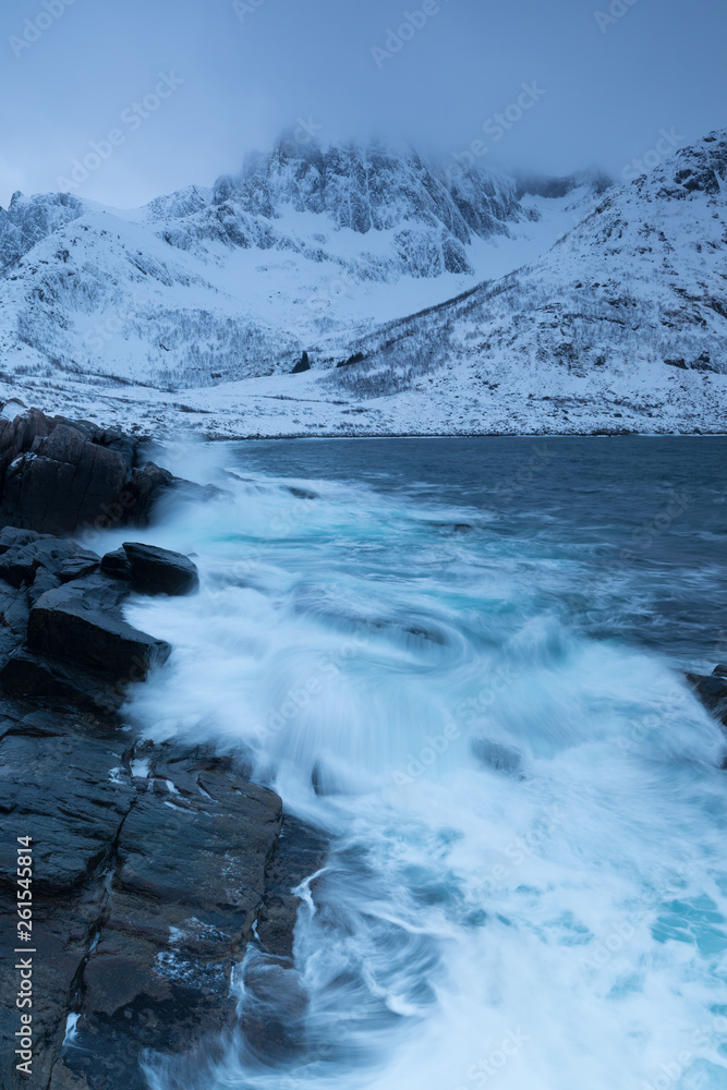 Amazing day in Mountains And Fjords, Winter Landscape, Norway Clouds sky on the Norwegian Alps and the blue hour begins in range at Senja, Norway. Beautiful christmas time near Troms county. Amazing day in Mountains And Fjords, Winter Landscape, Norway Clouds sky on the Norwegian Alps and the blue hour begins in range at Senja, Norway. Beautiful christmas time near Troms county.