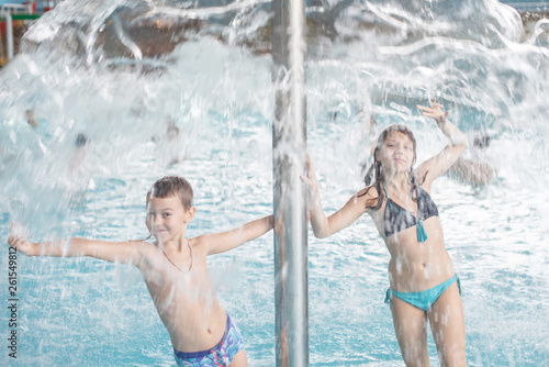 boy and girl having fun in the water park. blurred focus. 