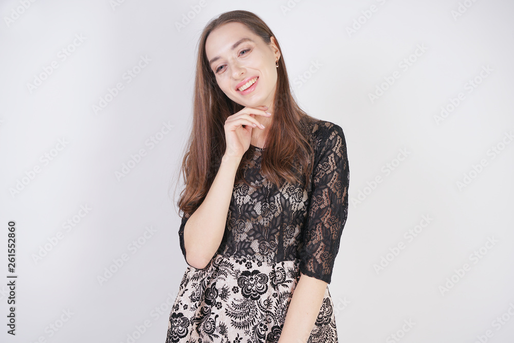 cute caucasian girl in a lace black dress stands on a white background in the Studio cute caucasian girl in a lace black dress stands on a white background in the Studio