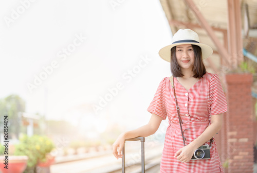 Cute girl with vintage camera and luggage