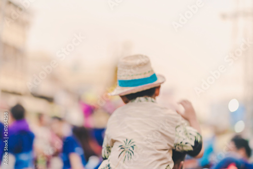 Blur of Happiness  villagers dressed in beautiful local costumes join the parade to celebrate Songkran Festival at Ban Nong Khao in Kanchanaburi, Thailand. © JinnaritT