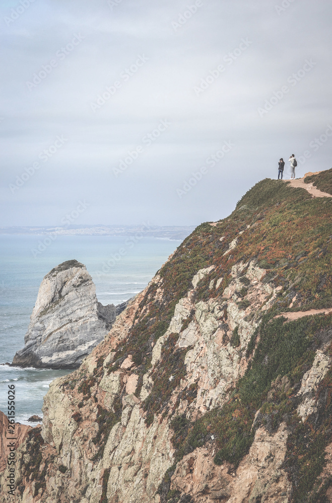Couple Man and Woman on a cliff enjoying the landscape Love and Travel happy emotions Lifestyle concept. Young family traveling active adventure vacations Couple Man and Woman on a cliff enjoying the landscape Love and Travel happy emotions Lifestyle concept. Young family traveling active adventure vacations