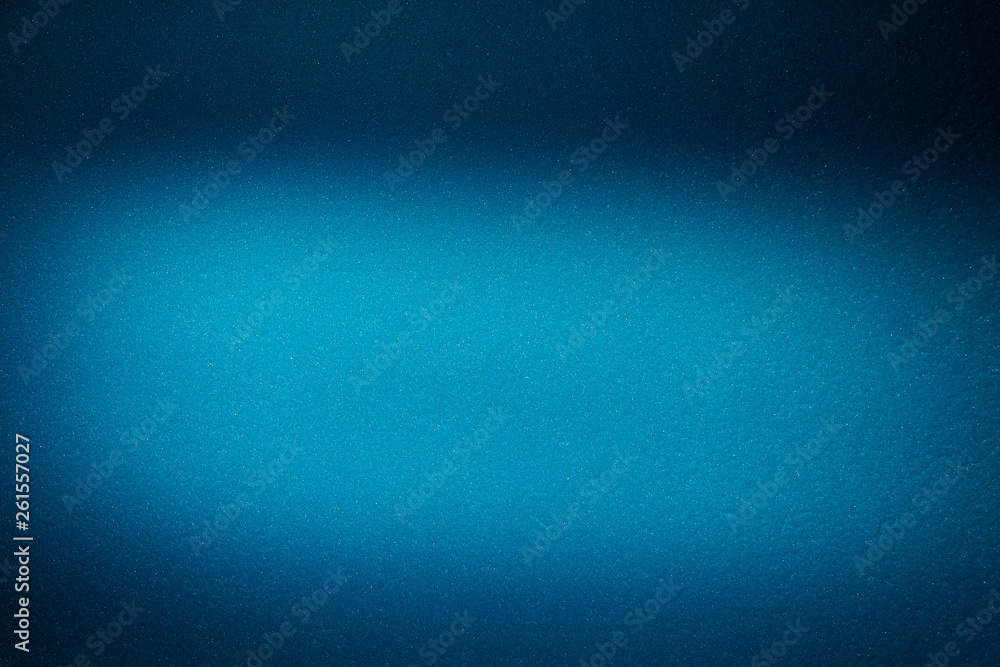 On the blue textural blurry background a light blue cloud of light On the blue textural blurry background a light blue cloud of light