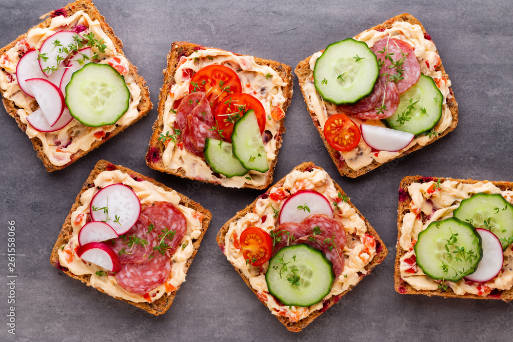 Sandwiches with cream cheese, vegetables and salami. Sandwiches with cream cheese, vegetables and salami.
