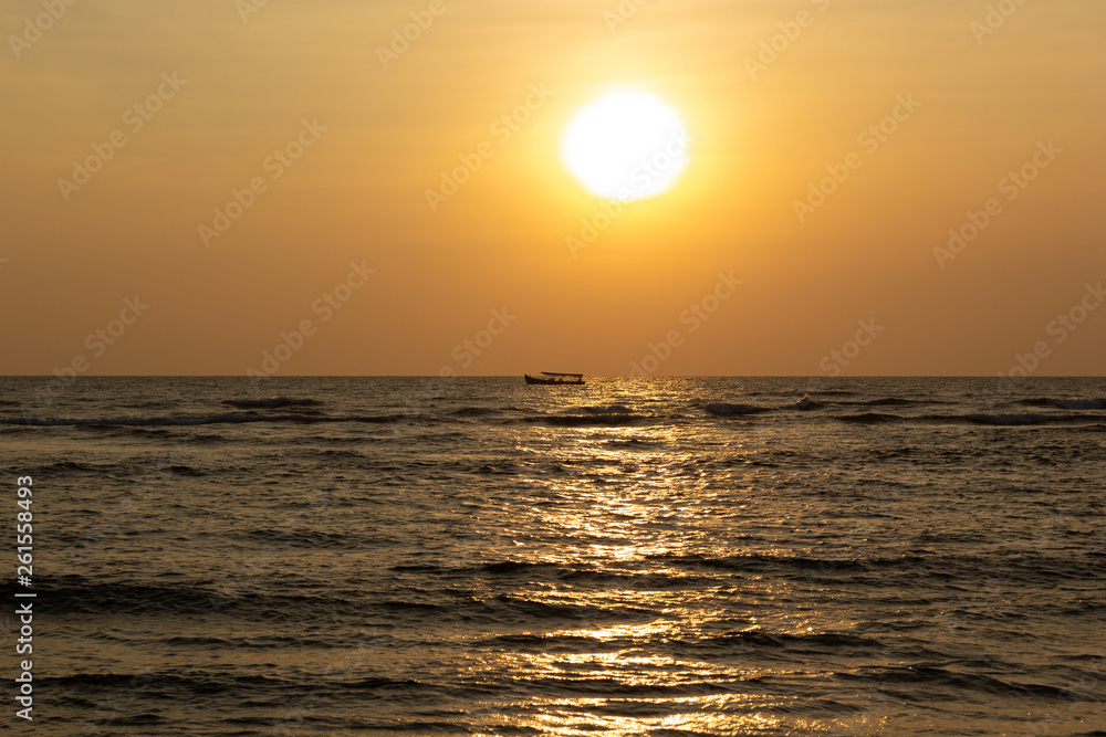 Landscape silhouette of a boat on the background of a magnificent sunset