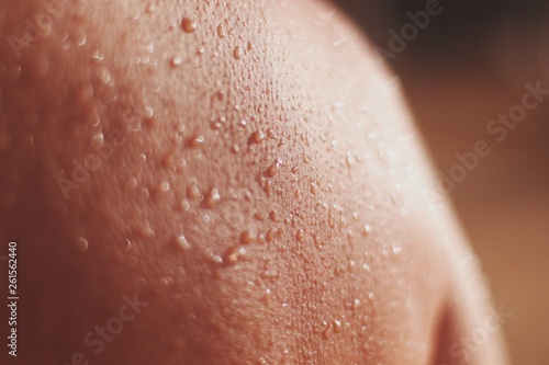 closeup of female skin with drops of a water