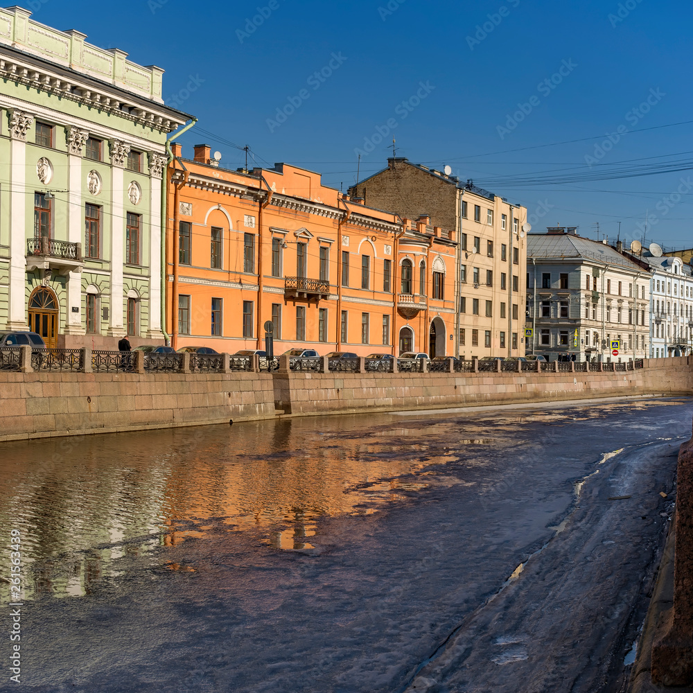 Reflections of houses in the river Moika Sunny April day in St. Petersburg.