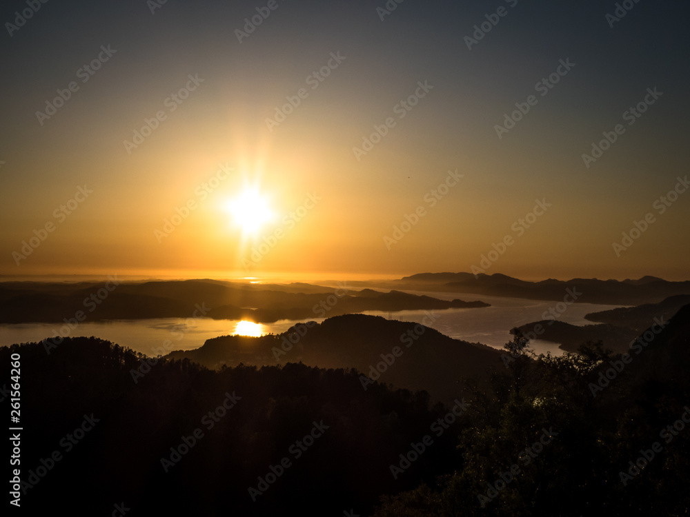 A beautiful and breathtaking view on fjords around Bergen, Norway, seen from the hill above the city. Endless fjords joining the sea. Sun sets over the horizon. Beauty of the nature.