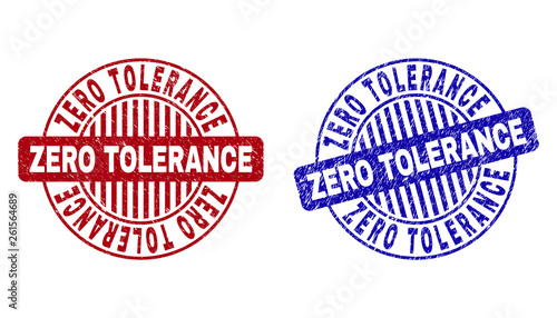 Grunge ZERO TOLERANCE round stamp seals isolated on a white background. Round seals with grunge texture in red and blue colors.