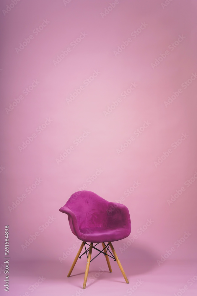 Chair on a light pink background. Studio paper background with props.  Purple designer armchair with a soft back and wooden legs on a purple  background. Stock Photo | Adobe Stock