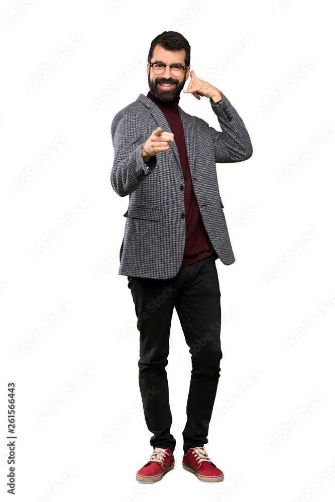Handsome man with glasses making phone gesture and pointing front over isolated white background Handsome man with glasses making phone gesture and pointing front over isolated white background